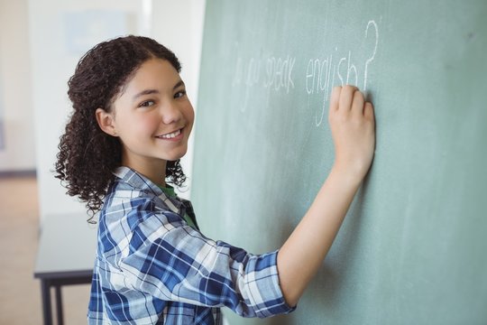 Portrait of schoolgirl pretending to be a teacher in classroom - Powered by Adobe