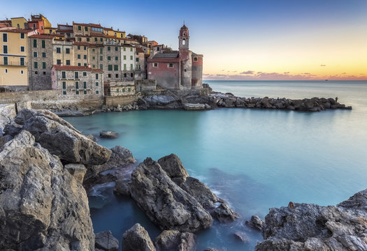 Tellaro town at sunset from it's rocks and little harbour, Lerici, La Spezia gulf, Liguria, Italy.