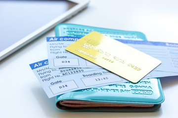 travel concept with passport, credit cards and flight tickets on light table