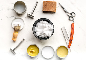 Tools for cutting beard in barbershop on workplace background top view