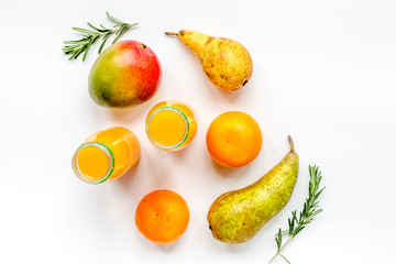 bottles of smoothie with fruits on white table top view
