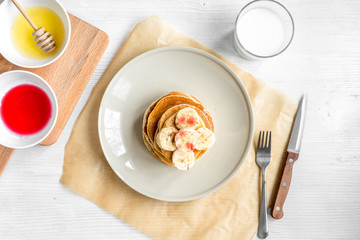 cooked pancake on plate top view at wooden background