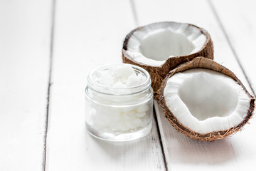 Obraz na płótnie Canvas coconut oil for body care in cosmetic concept on white desk mock up
