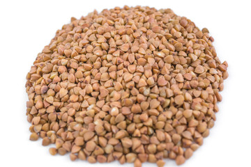 Handful of buckwheat on a white background, close-up