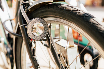 Fototapeta premium Close Up Of Bike Headlight And Wheel Of Bicycle On Street. Bike 