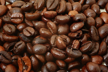 Roasted brown coffee beans on the table