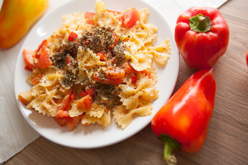 farfalle with tomatoes and italian cheese parmesan on plate