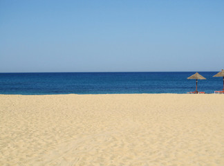 Fototapeta na wymiar Summer stripes: sandy beach, blue sea, limpid sky.