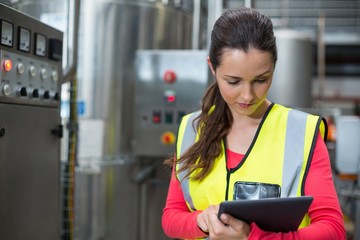 Female factory worker using digital tablet