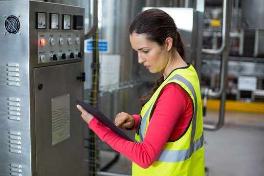 Female factory worker using digital tablet