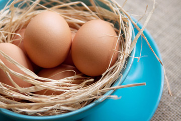 Brown chicken eggs on a blue plate