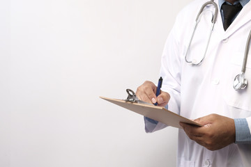 Doctor holding clipboard with sheet of paper .