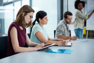 Business executive using digital tablet in meeting