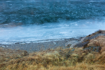 Iced lake and rocky beach