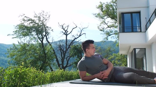 man doing exercise on terace in front of villa