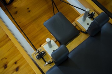 Close-up of reformer on wooden floor