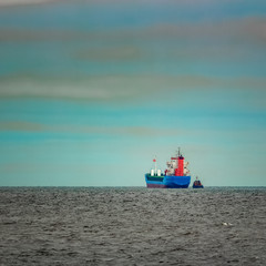 Blue cargo ship entering the Baltic sea. Riga, Europe