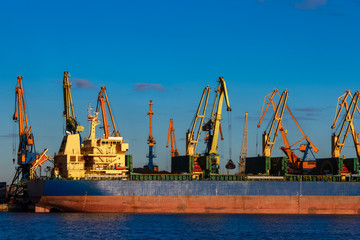Obraz premium Blue cargo ship loading in the port of Riga, Europe