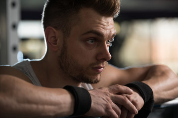 Attractive Young Man Resting In Gym Afther Exercise