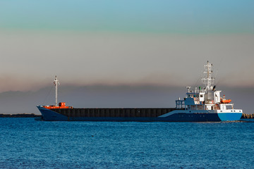 Blue cargo ship leaving Riga and entering Baltic sea