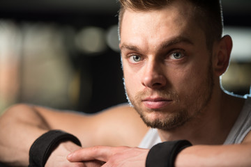 Muscular Man Resting On Bench After Exercise