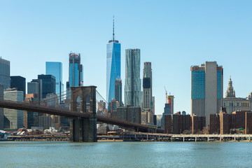 View of Brooklyn Bridge and Manhattan skyline WTC Freedom Tower from Dumbo, Brooklyn. Brooklyn Bridge is one of the oldest suspension bridges in the USA
