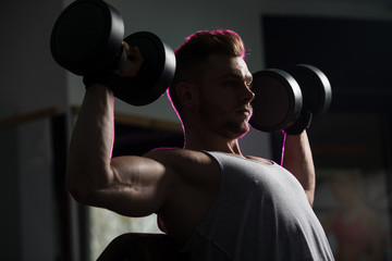 Fototapeta na wymiar Shoulders Exercise In A Gym