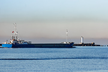 Blue cargo ship leaving Riga and entering Baltic sea