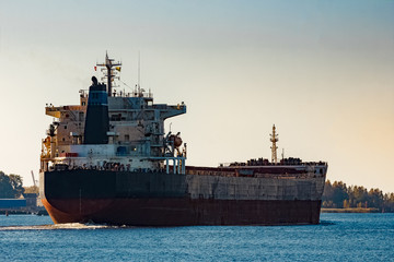 Obraz premium Black cargo ship entering Riga, Europe