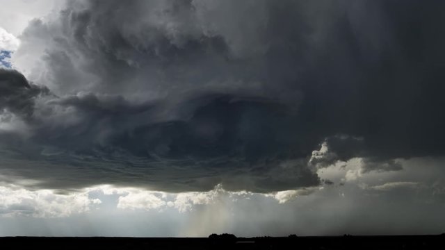 High-level base of a thunderstorm showing updraft and rotation, as hail pours, time lapse
