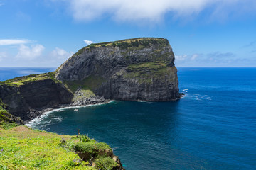 Fototapeta na wymiar Morro do Castelo Branco, a scenic old rock overlooking the sea in Faial Island, Portugal, Azores