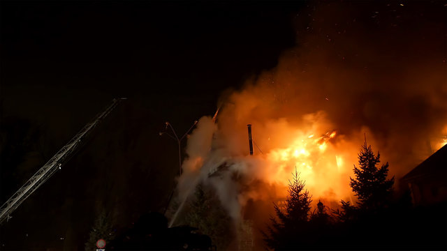 House building on fire at night. Blaze Inferno conflagration and combustion.