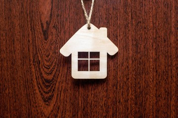 House symbol on a brown wooden background