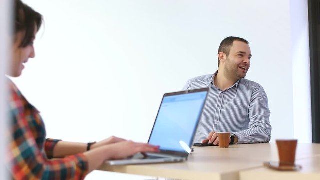 startup company meeting, woman using laptop on meeting