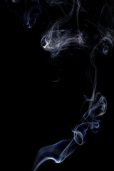Abstract art. Color white blue smoke from the aromatic sticks on a black background. Background for Halloween. Texture fog. Design element. The concept of aromatherapy.