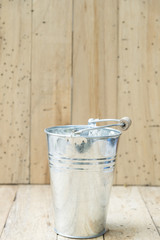 bucket of water on wood background, vintage filtered Images