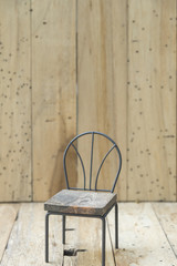 mini model chair with wooden wall