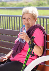 Senior woman resting after nordic walking, sporty lifestyles in old age