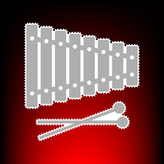 Xylophone sign. Postage stamp or old photo style on red-black gradient background.