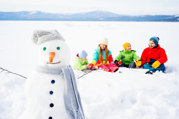 Family sitting in snow