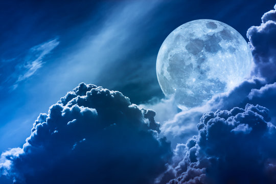 Super moon. Nighttime sky with clouds and bright full moon with shiny.