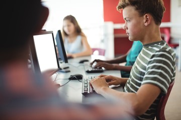 Students using computer in classroom