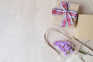 Gift box and bouquet flower on wooden background. Copy space.