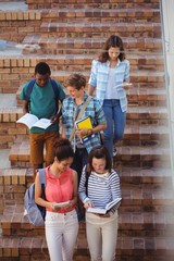 Fototapeta premium Students moving down staircase