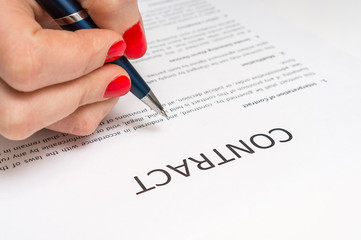 Business woman signing contract document in office