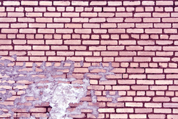 Old purple toned weathered brick wall texture.