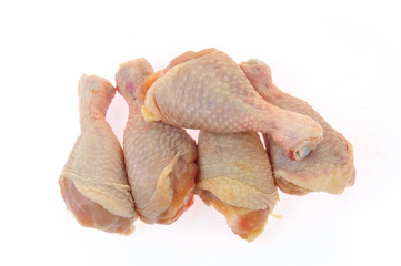 Raw chicken leg on a white background