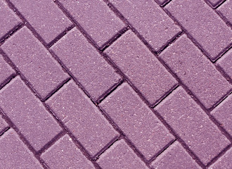 Violet color cobblestone pavement close-up
