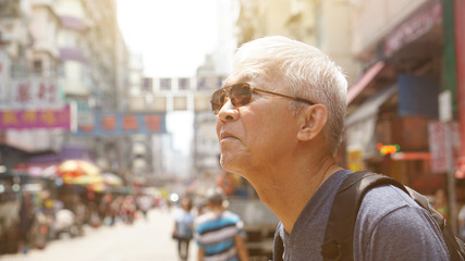 senior man with hong kong urban architecture scene