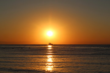 The boat in the rays of the rising sun